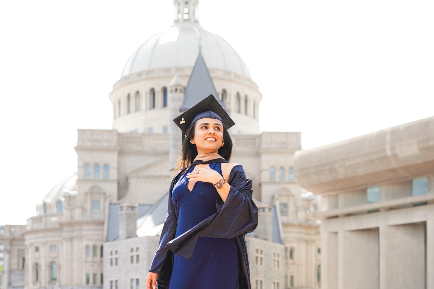 Graduation portrait in navy before the Mother Church dome