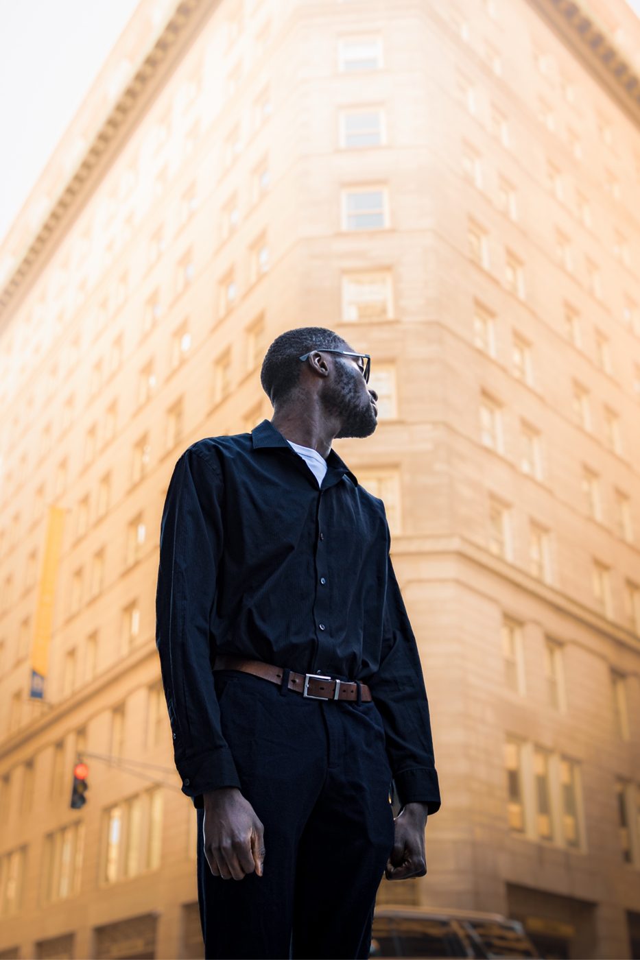 Portrait in a black shirt against the city